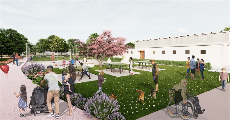 Where Generations Unite: table tennis on the grass under a flowering cherry, the sports hall to the right.