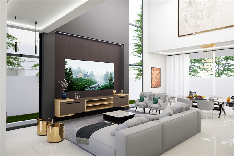 The double-height lounge, with a dark timber media wall facing a corner sofa and glazing to the garden on both sides.